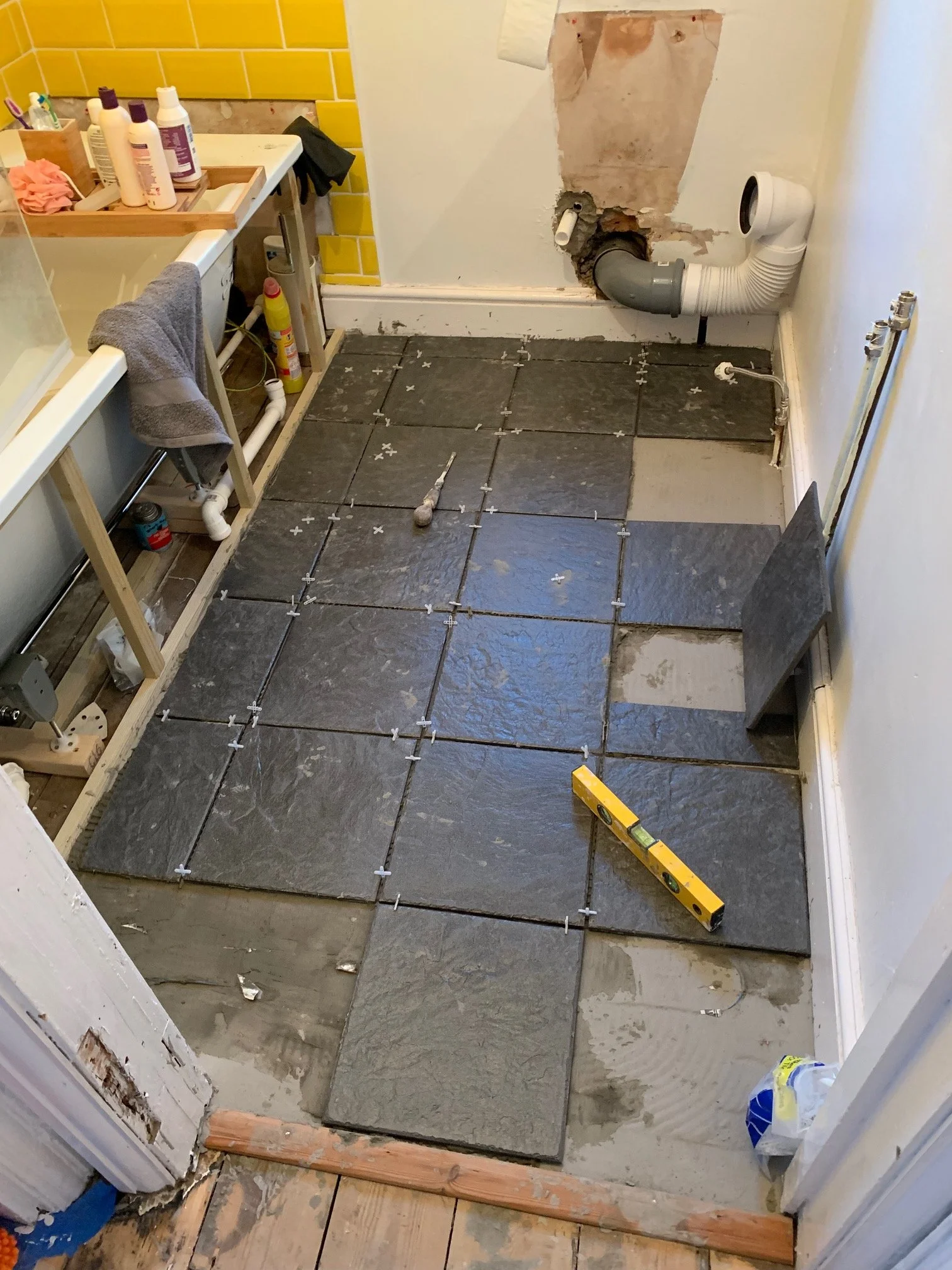 Bathroom Refurbishment Uxbridge. Rip out, relocate the toilet and sink. Light plumbing. Tiling.