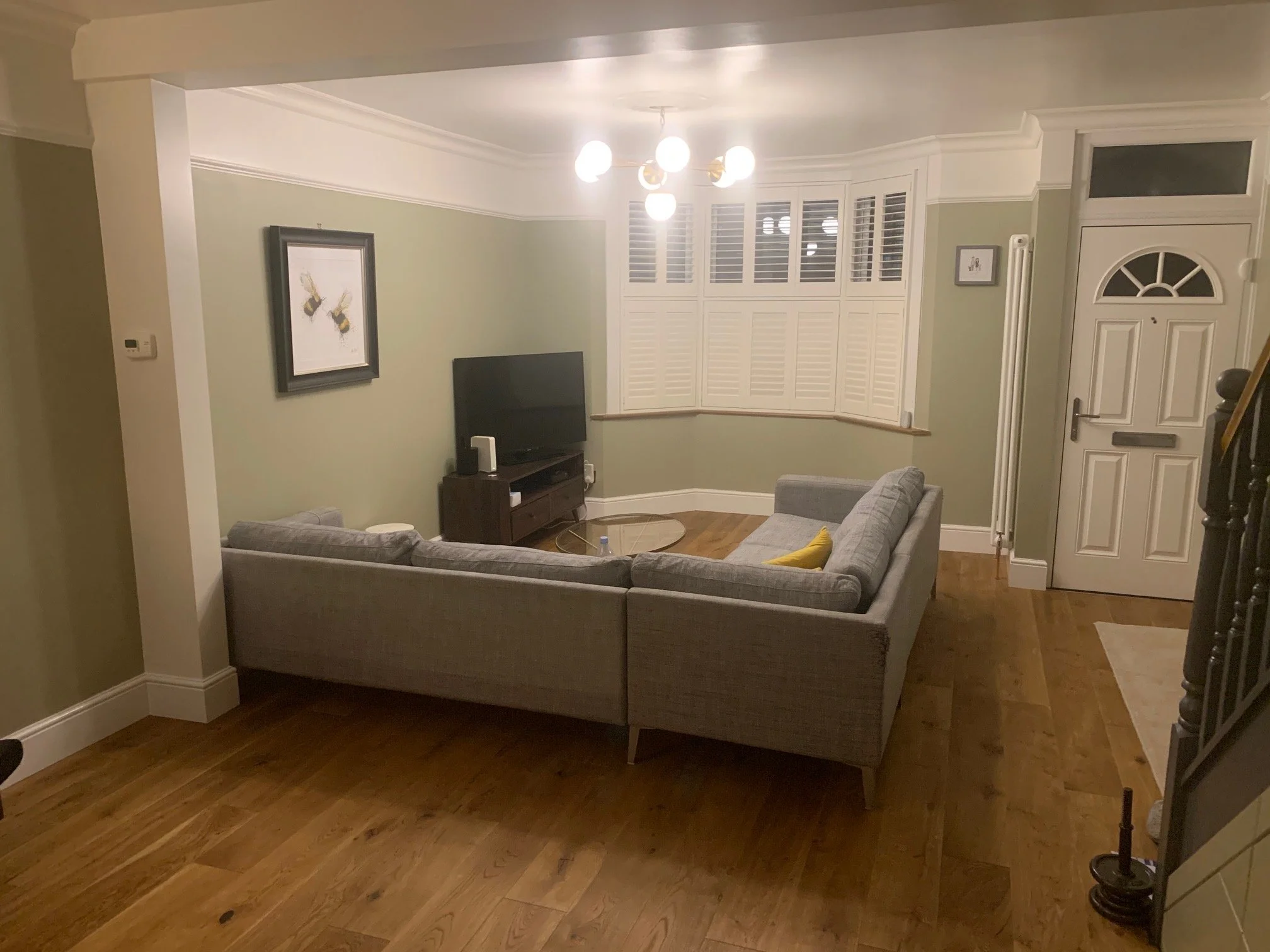 Living room redesign Uxbridge. A couple of walls were removed, leaving a large open plan room. The floors were all sanded and varnished initially. Interior design scheme was agreed and we went on to paint all the walls and cieling. Install coving and