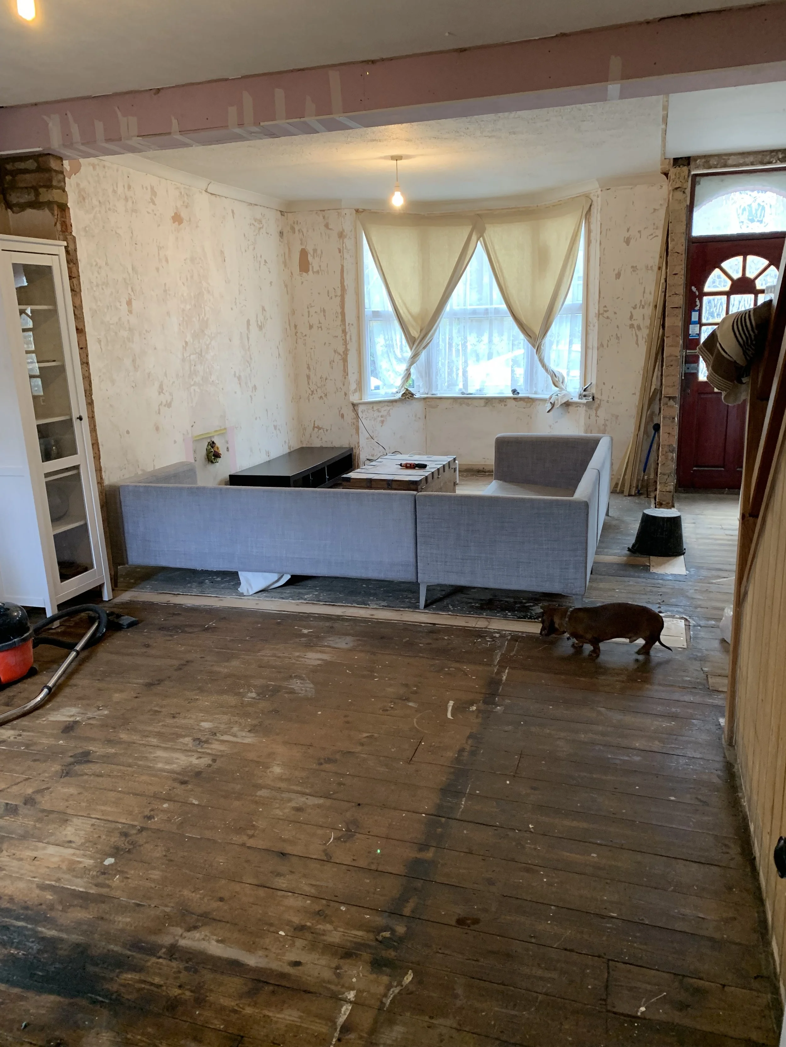 Living room redesign Uxbridge. A couple of walls were removed, leaving a large open plan room. The floors were all sanded and varnished initially. Interior design scheme was agreed and we went on to paint all the walls and cieling. Install coving and