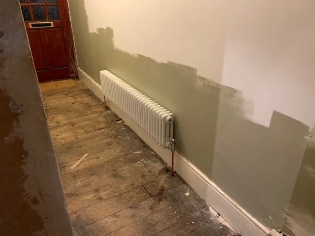 Living room redesign Uxbridge. A couple of walls were removed, leaving a large open plan room. The floors were all sanded and varnished initially. Interior design scheme was agreed and we went on to paint all the walls and cieling. Install coving and