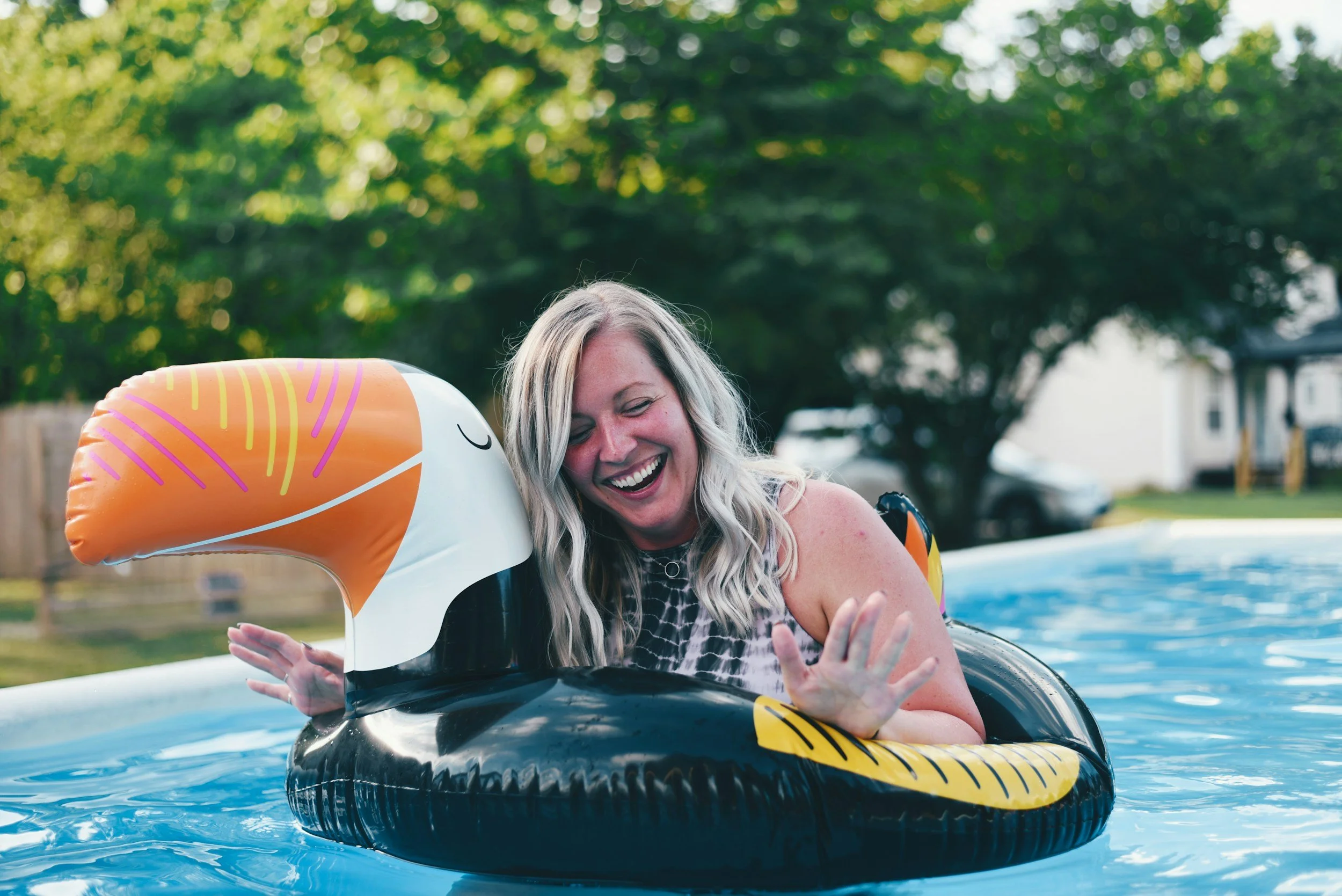 Homeowner relaxing by a well-maintained backyard pool in Chenal neighborhood of Little Rock, AR.