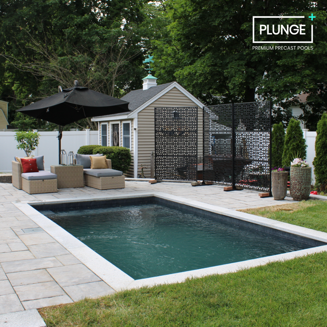 Backyard with a small swimming pool, patio furniture including a black umbrella, potted plants, and a small shed.