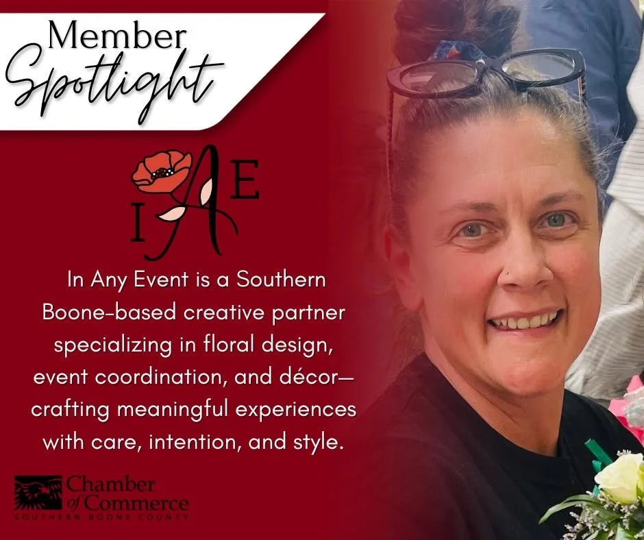 A woman with glasses on her head, smiling at the camera, in front of a red background with text about her being a floral design and event coordination creative partner, part of a Member Spotlight for the Chamber of Commerce.