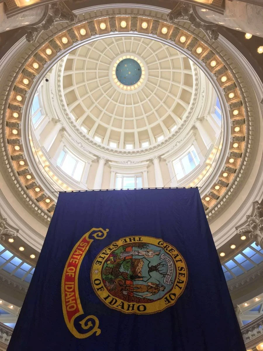 large Idaho State flag hanging inside the Idaho State Capitol Building