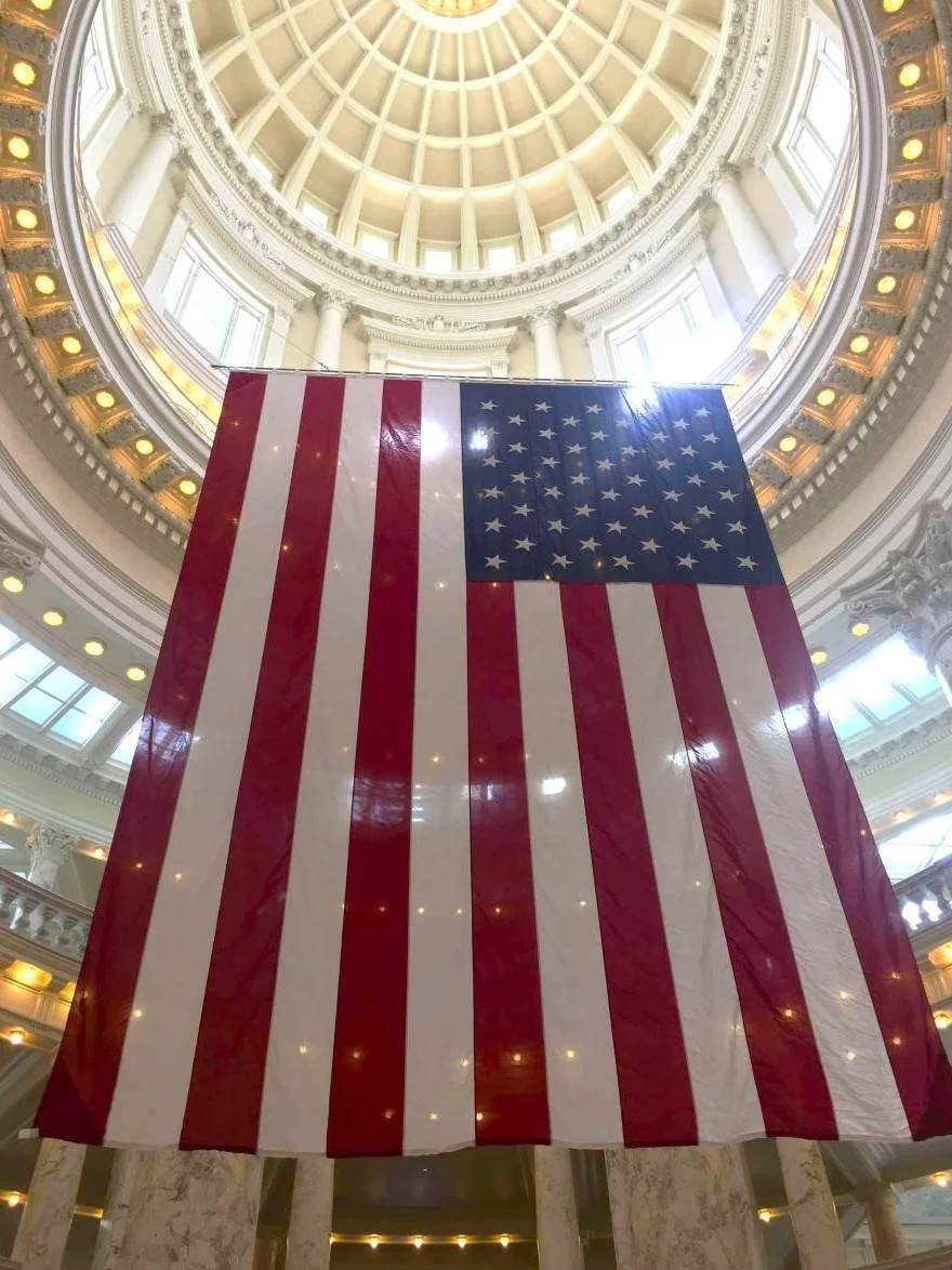 Large American flag inside the Idaho State Capitol Building