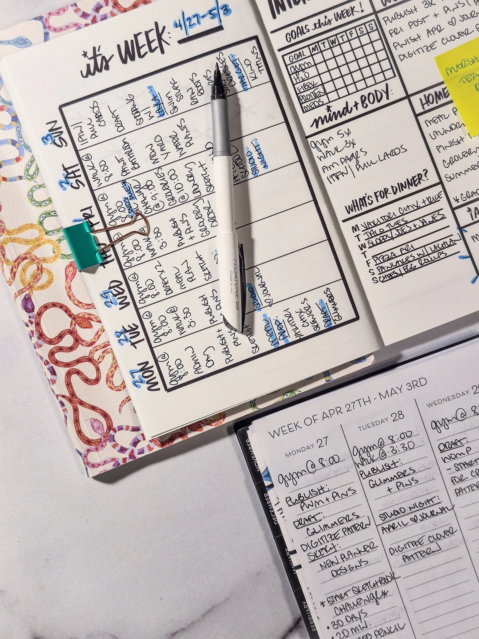 Minimal structured weekly planner spread filled with handwritten tasks and highlighted sections, styled with pen and binder clip