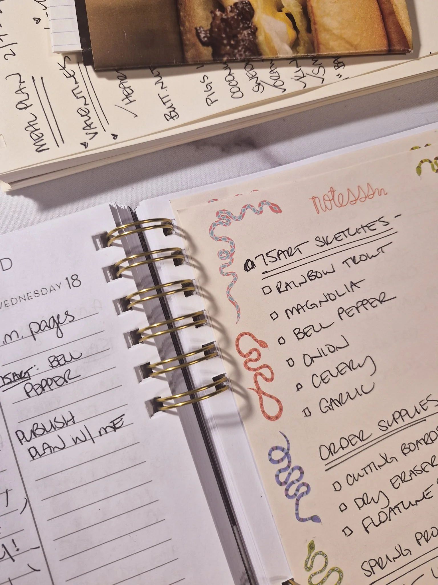 creative planning closeup shot of monthly planner with sticky notes in the pages with to do lists for the next couple weeks