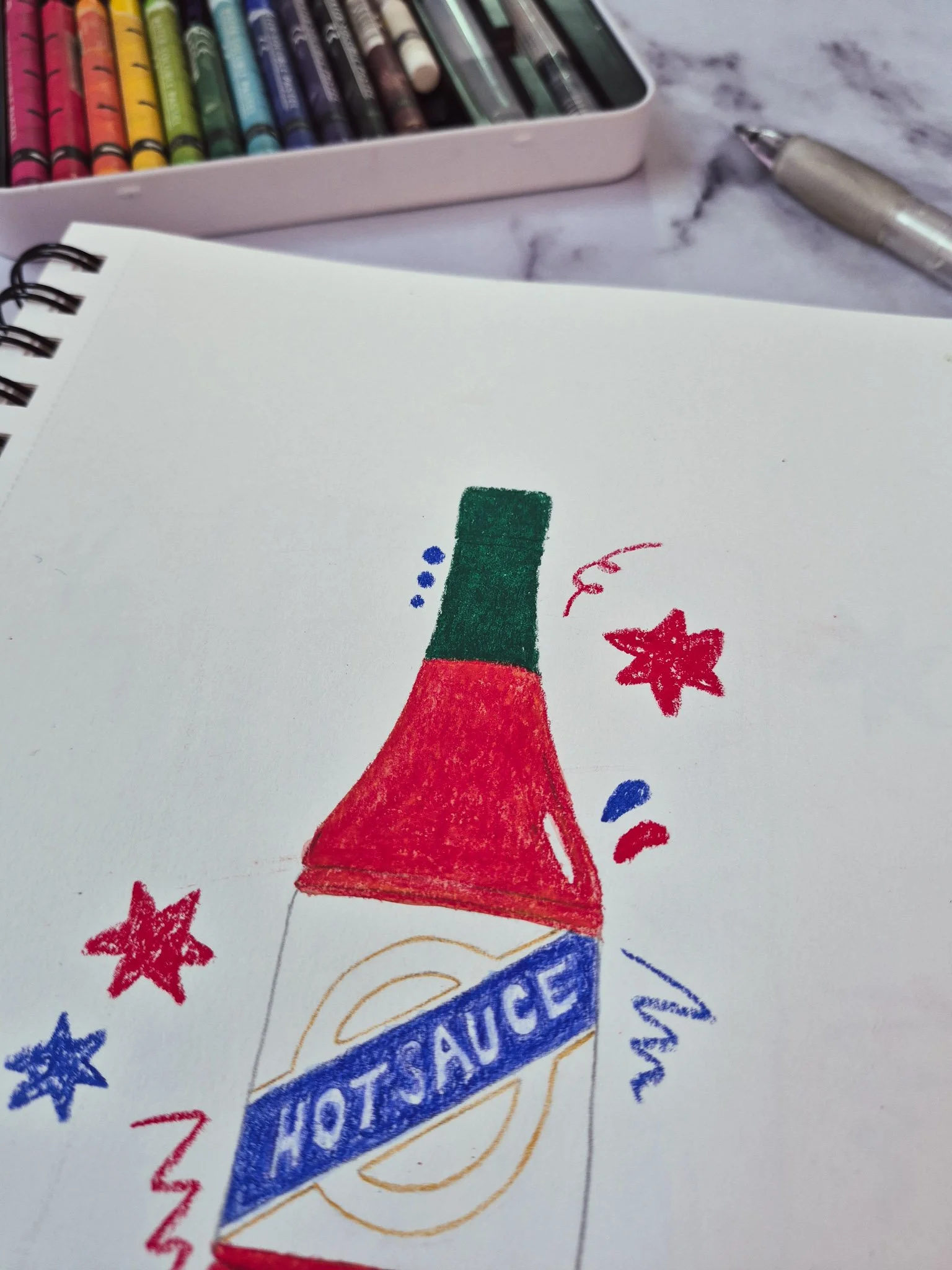 75 Art illustration of a hot sauce bottle drawn in a sketchbook with water pastels next to it on a marble background