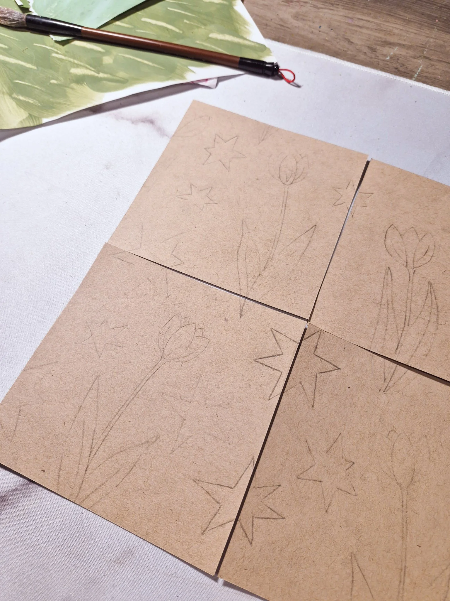 A completed hand-drawn analog repeat pattern made from four paper squares.