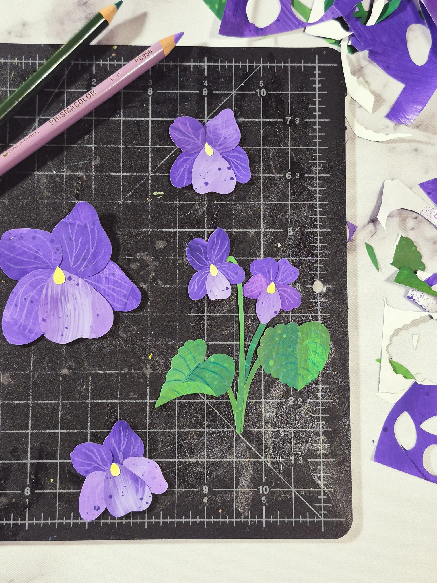 cozy creative desk space with painted paper collage wild violet motifs and mixed media materials