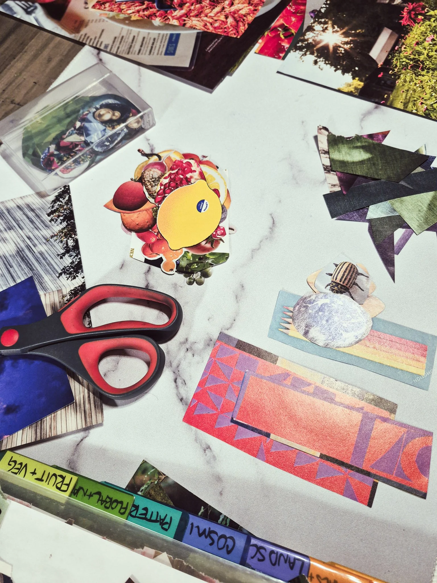 desktop photo of magazine collage pieces being organized into tinker trays