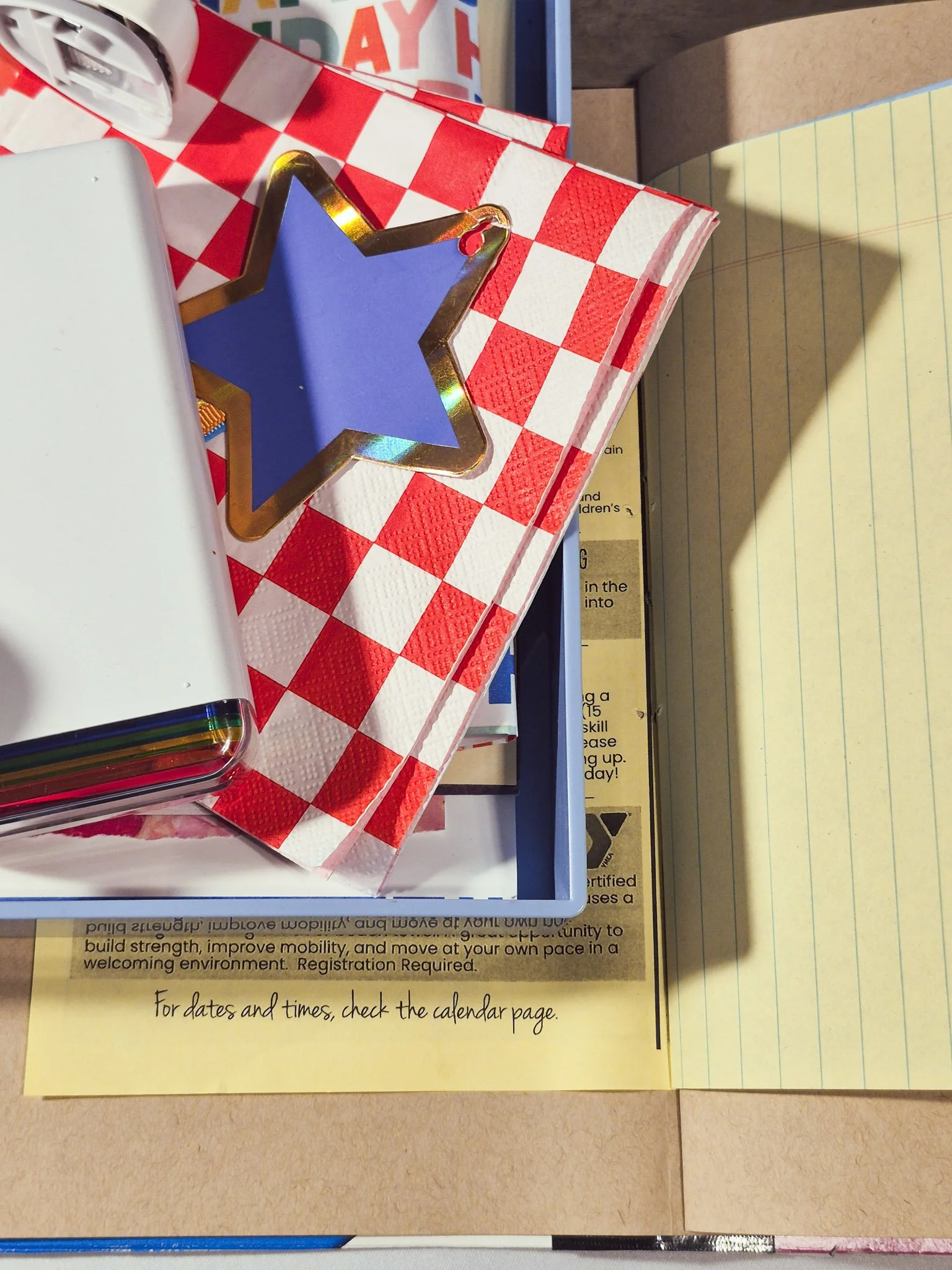 overhead image of completed heART journal open on desk with a tray of ephemera and photos to put inside