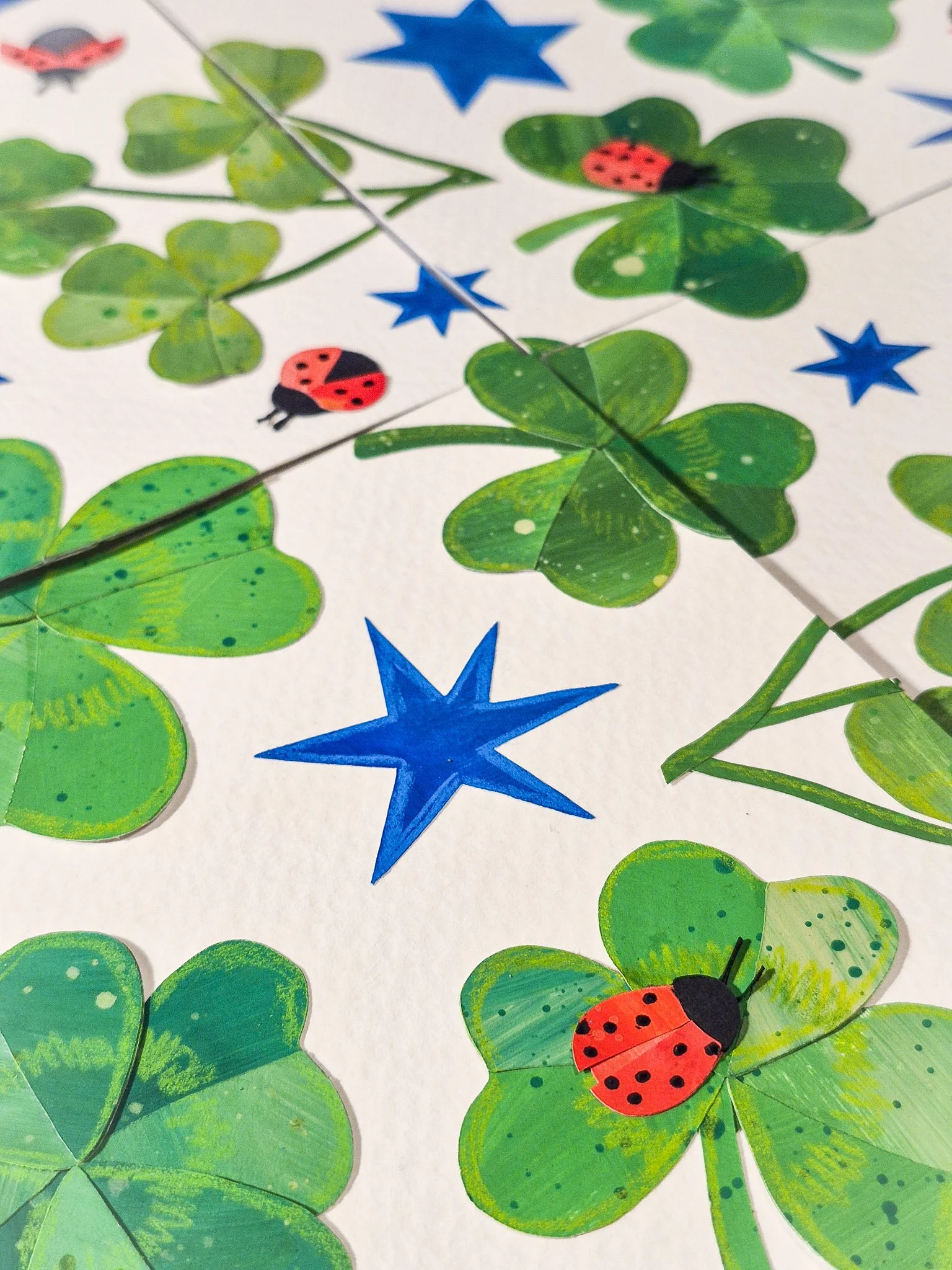 Handmade collage repeat pattern tiles aligned on a grid, showing how elements connect across edges to form a seamless design