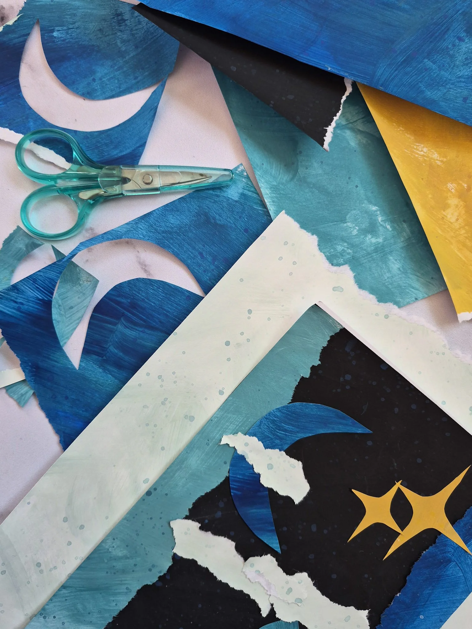 scissors and collage scraps from hand-painted paper