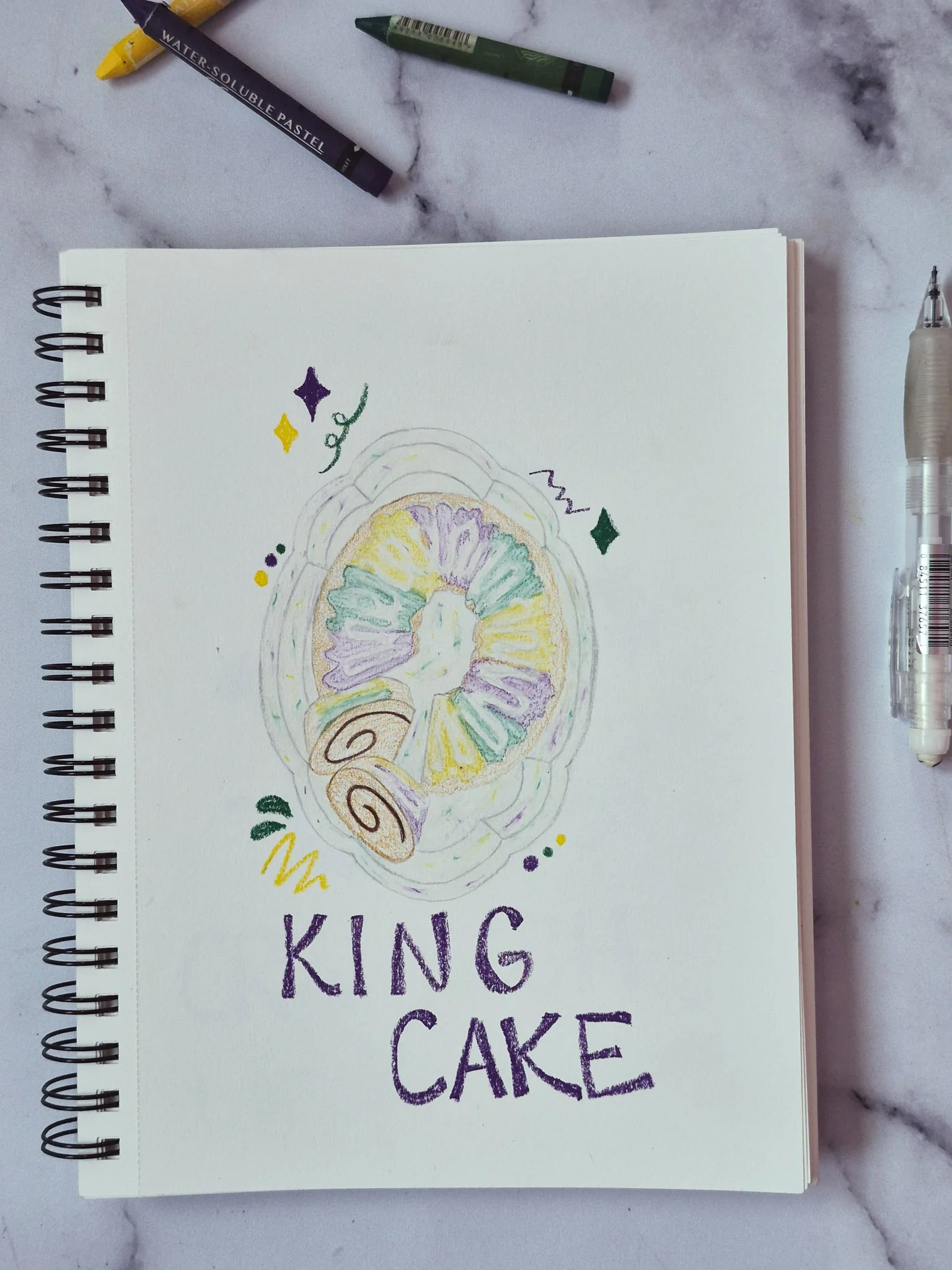 close detail of 75 art challenge king cake illustration using colored pencils and water pastels