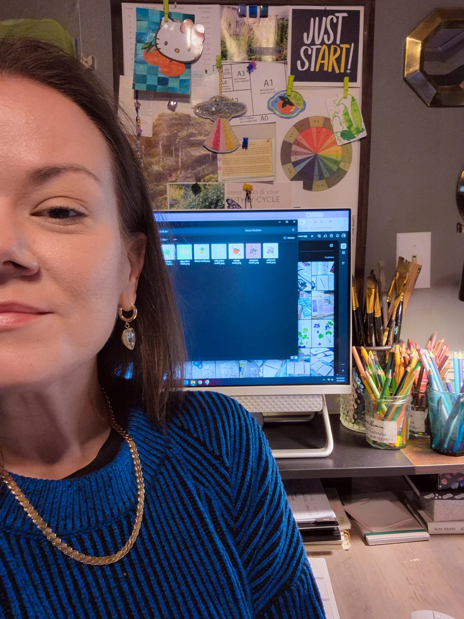 Creative workspace with art supplies, desk organization, and artist selfie in cozy studio