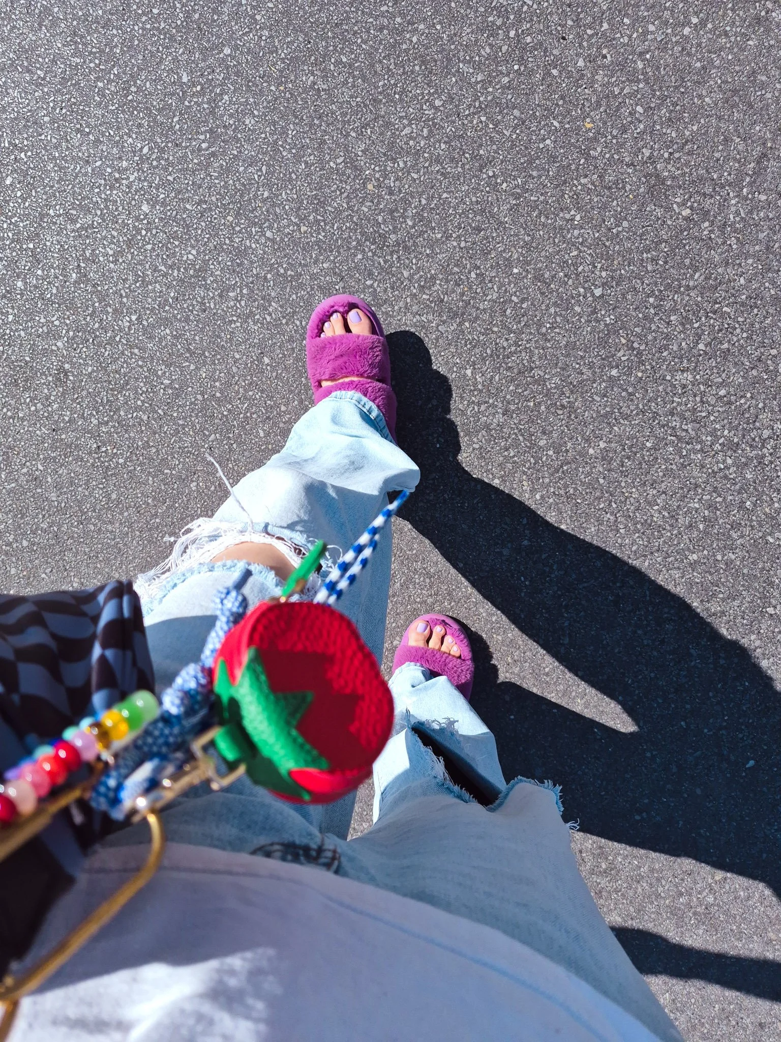 overhead image of the artist's legs and feet and purse with colorful bag charms  walking to her artist date