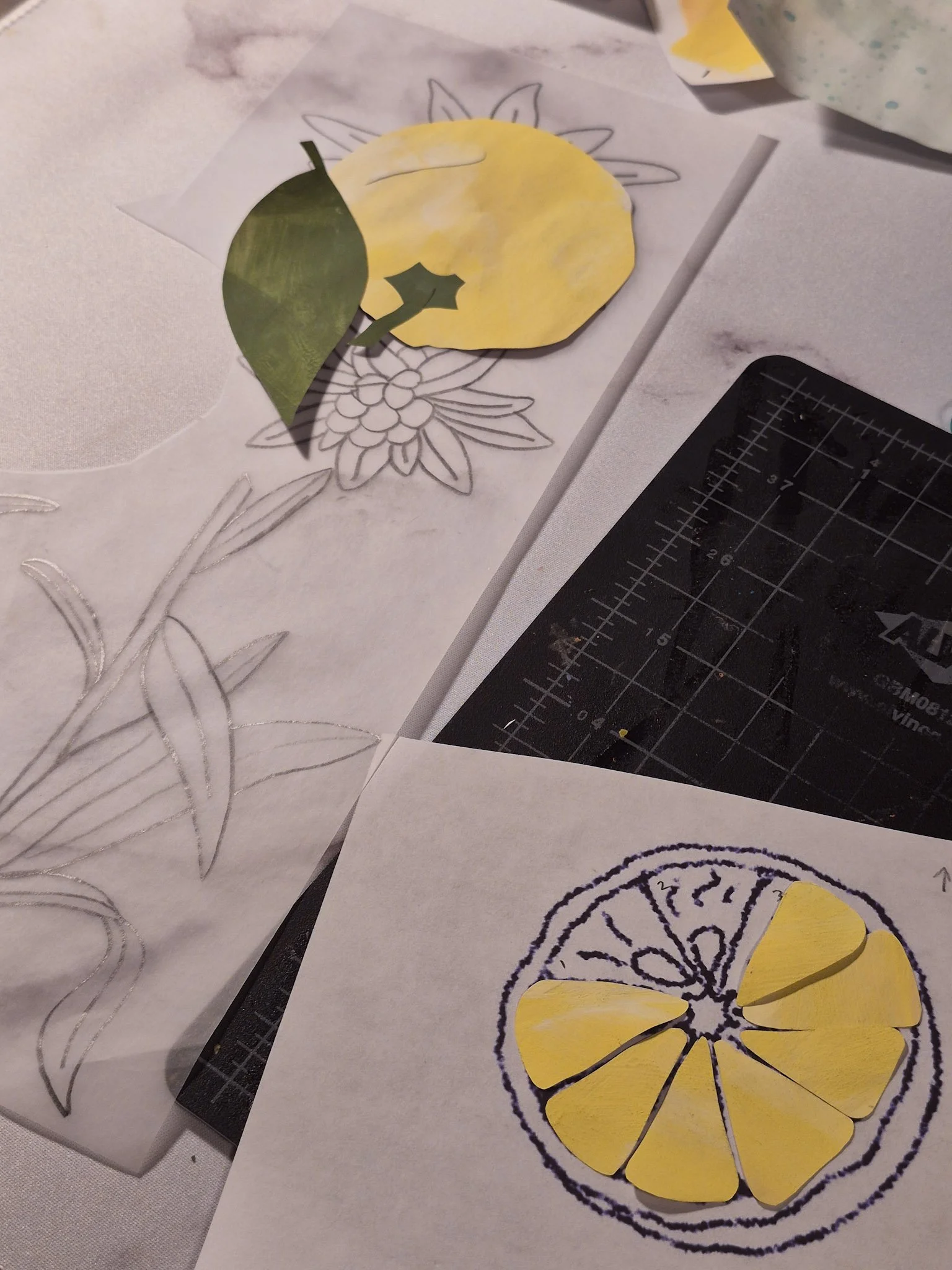 overhead shot of yuzu collage pieces being lined up against a template before being glued together