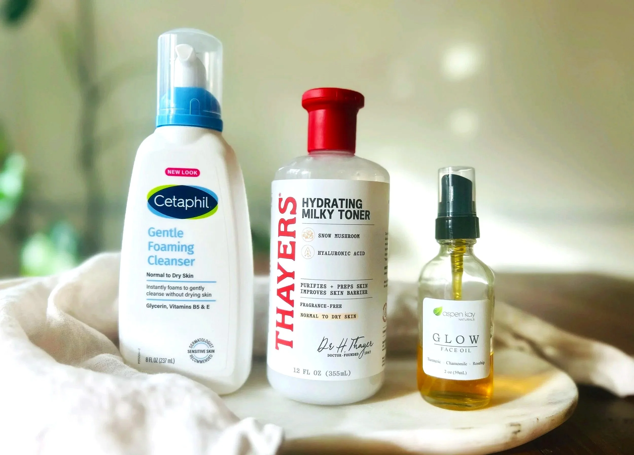 Gentle skincare routine with foaming cleanser, milky toner, and face oil on neutral background