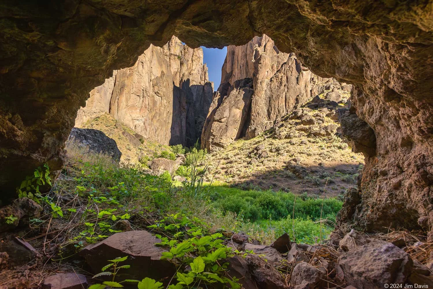 Owyhee Canyon view through an opening at rock formations with sunlight across them