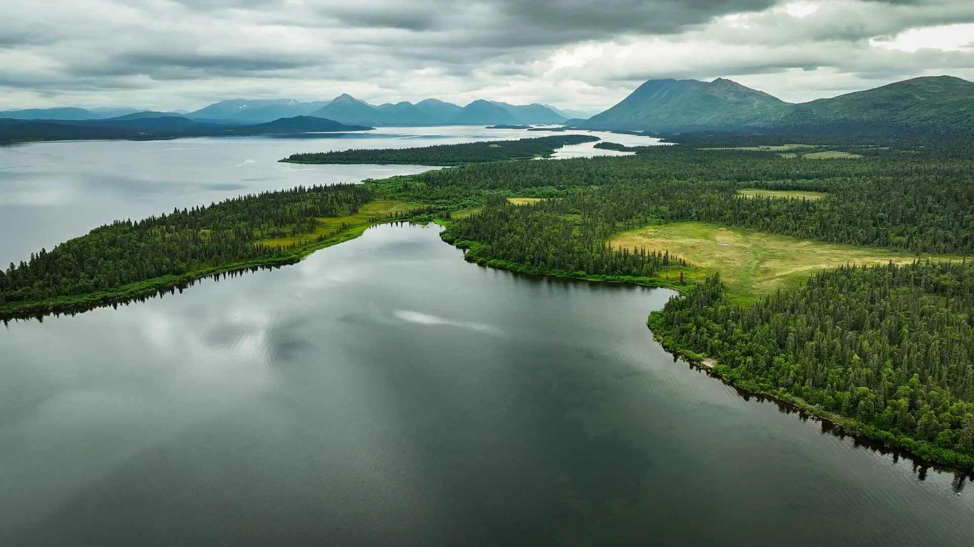 A view of Lake Aleknagik taken from above with mountain ranges in the distance