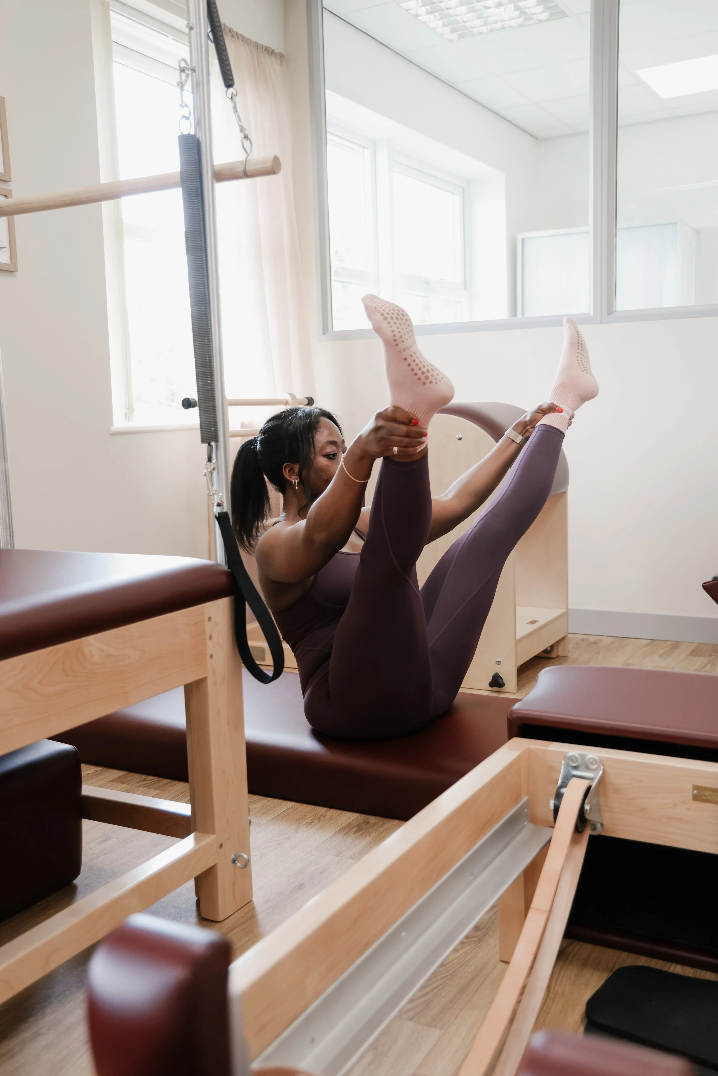 Open Leg Rocker on the Mat at FUNLAYO Classical Pilates studio in St Asaph.