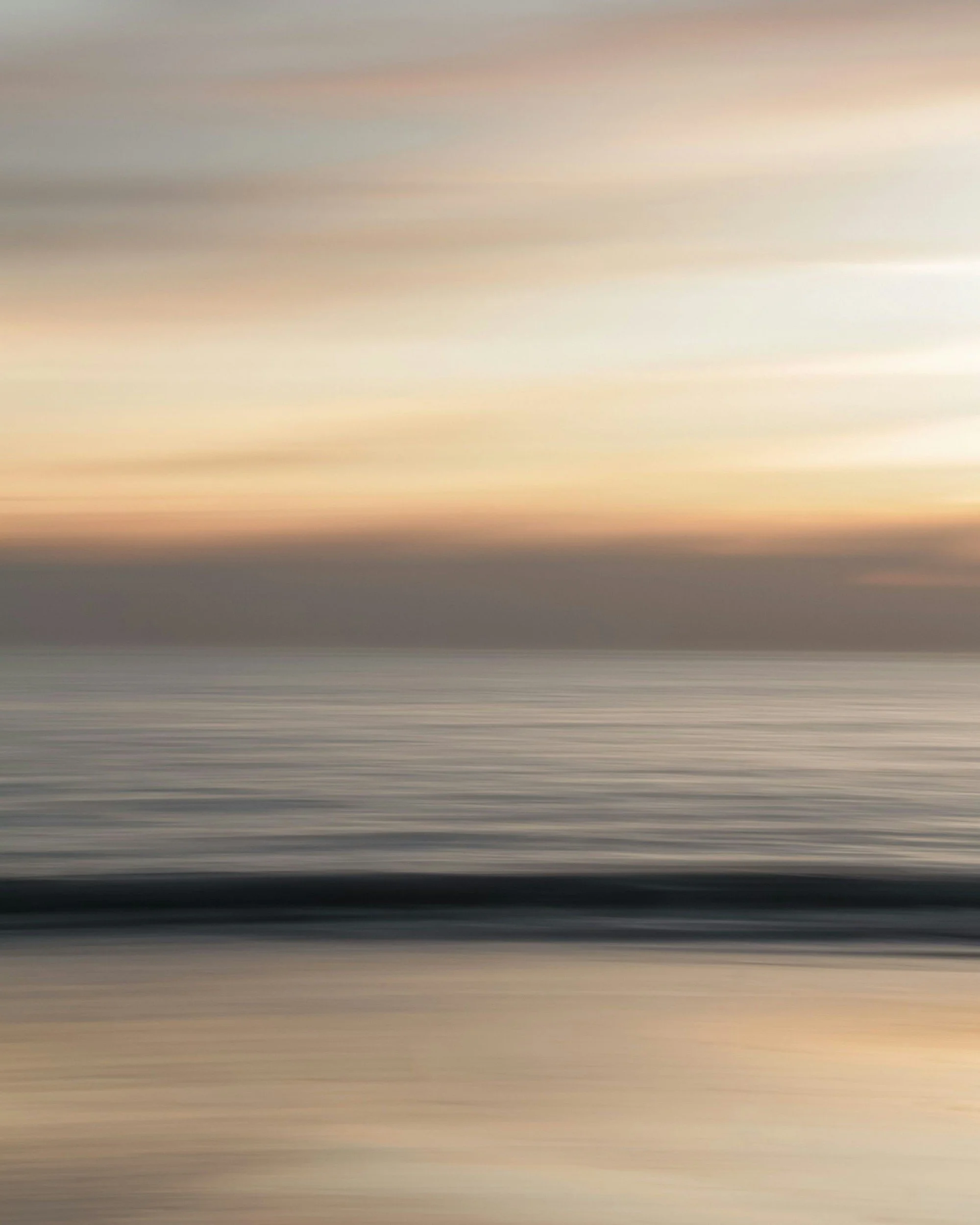 Richly blurred image of a sunset over a calm beach