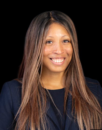 Anissa Douglass, founder of Anissa Studio, wearing a dark blazer against a black background.