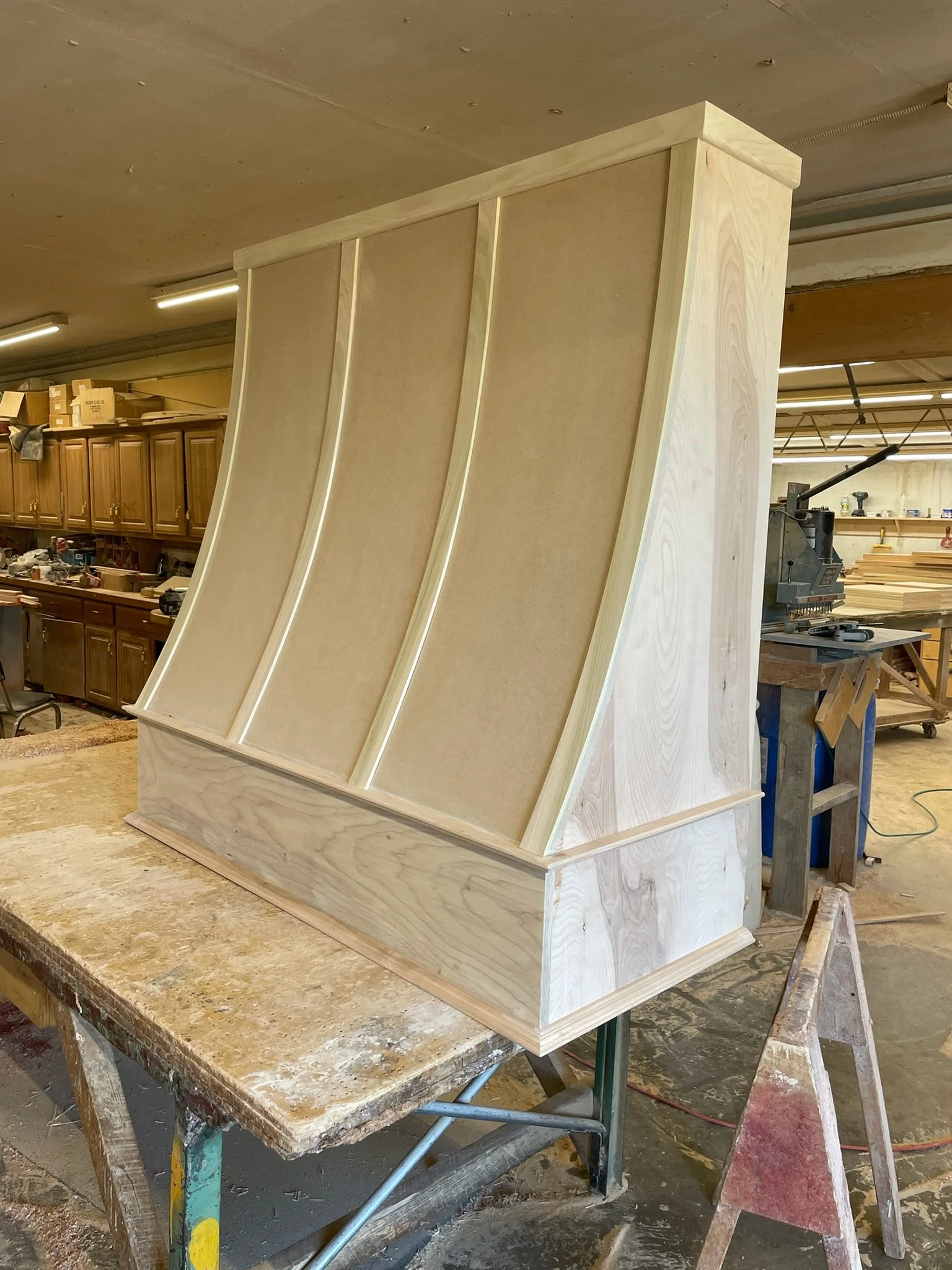 Wooden structure under construction in a woodworking shop.