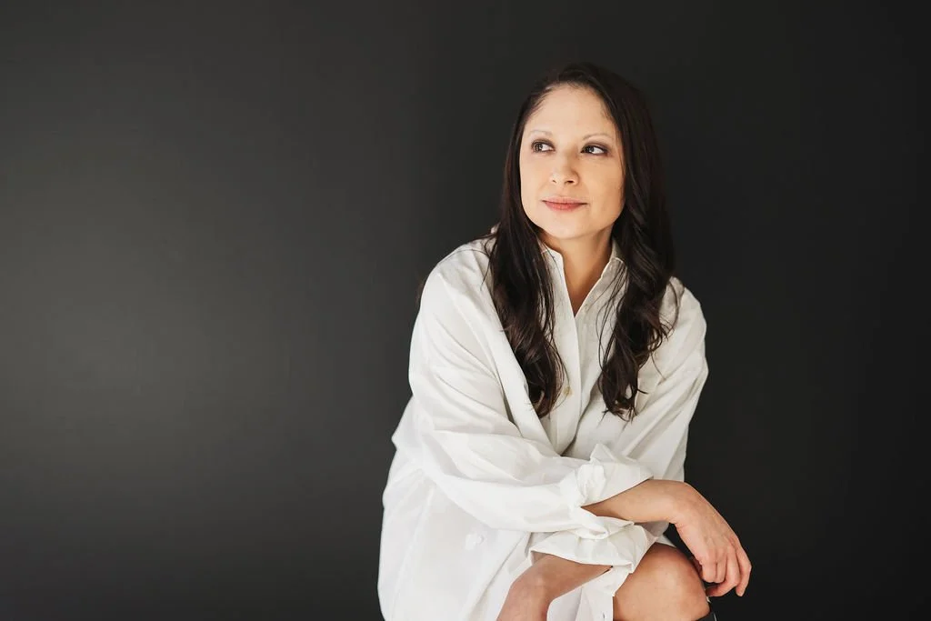Woman smiling looking away in white dress black and white photo