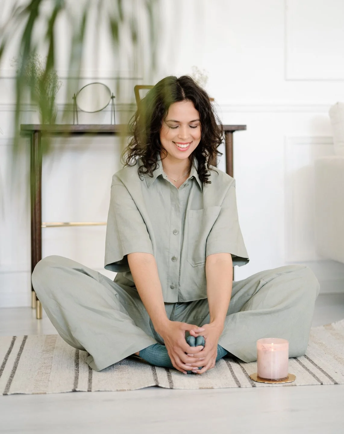 Woman on the floor stretching by a candle