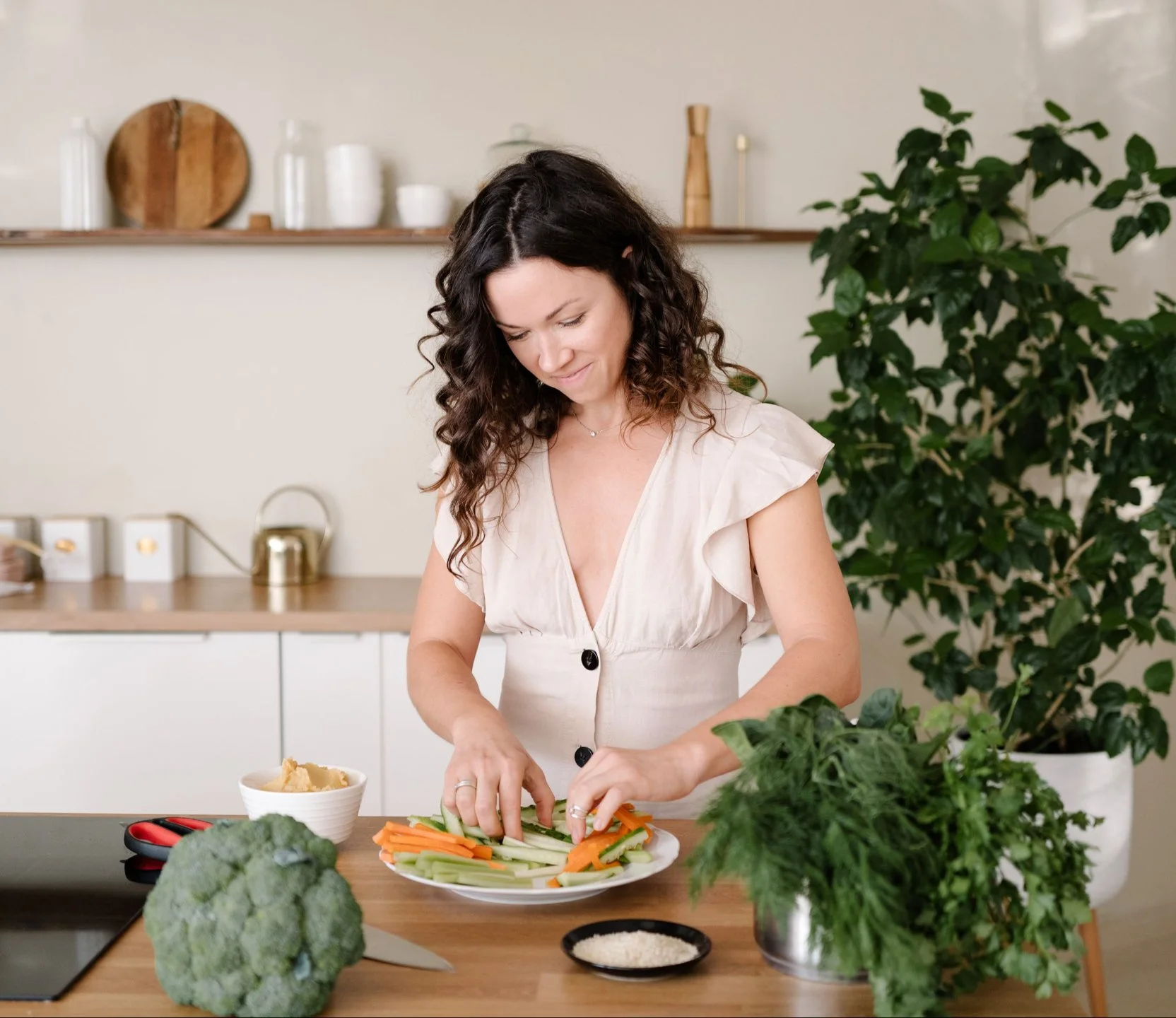Woman chopping healthy veggies in a kitchen
