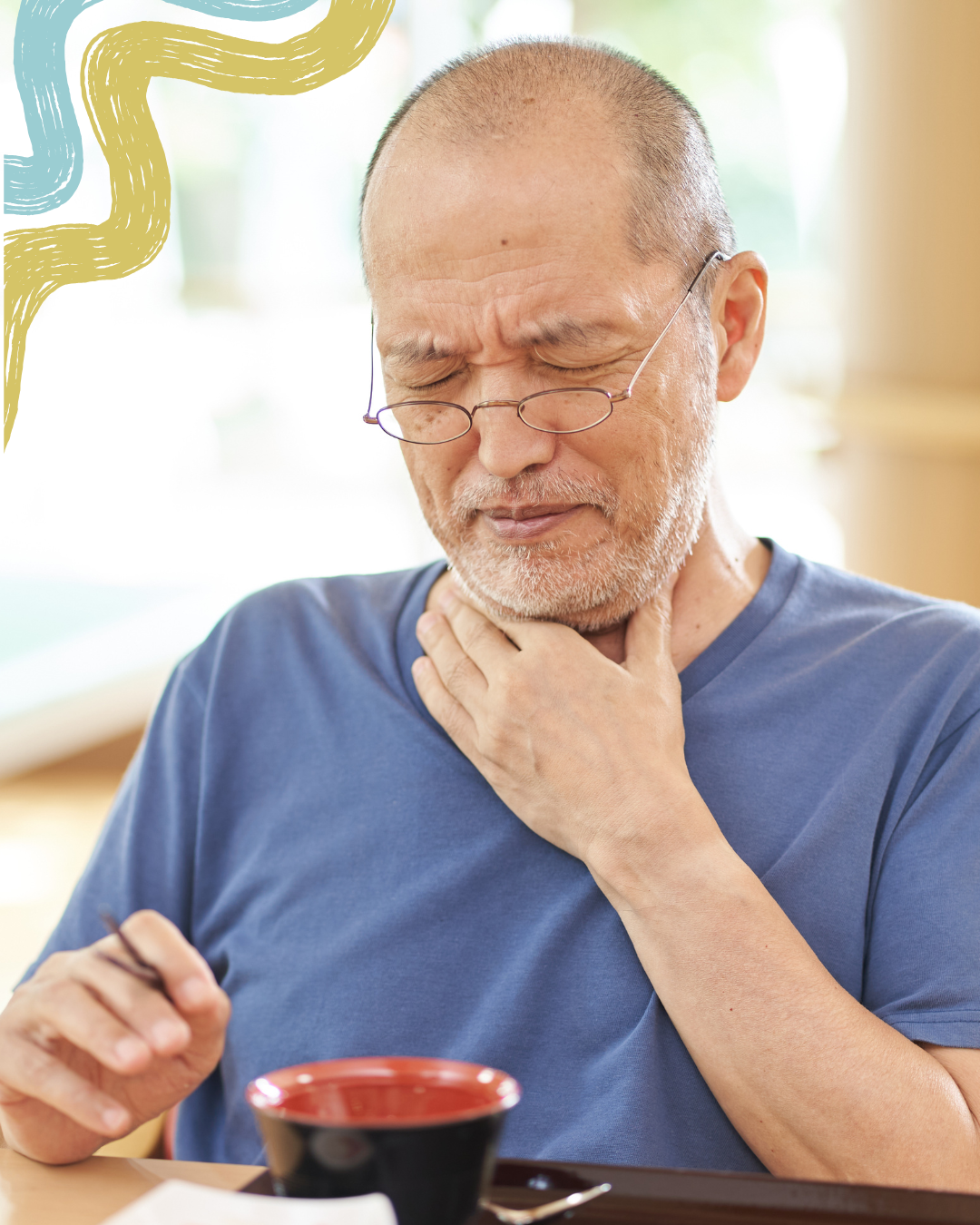 An older man with glasses and a beard, wearing a blue shirt, appears to be experiencing a sore throat or discomfort, holding his neck with one hand and a pair of chopsticks in the other, sitting at a table with a bowl.