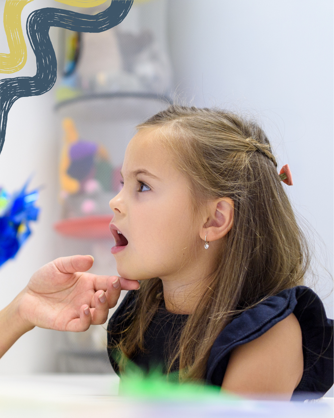 A young girl with light brown hair and earrings receiving a health checkup, her mouth open and head tilted back slightly.