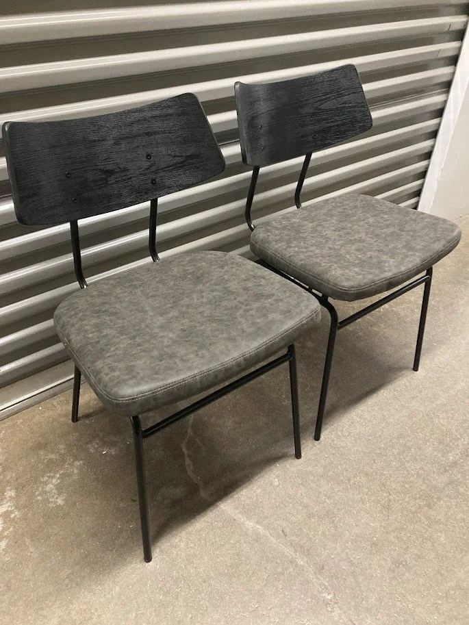 Angled view of Walker black and dark gray dining chairs