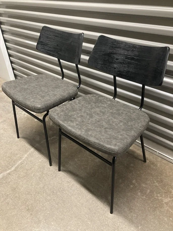 Close up of dark gray upholstered seat on Walker dining chair