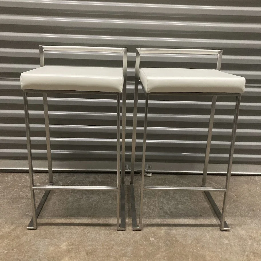 angled view of Fuji white faux leather counter stools with stainless steel base