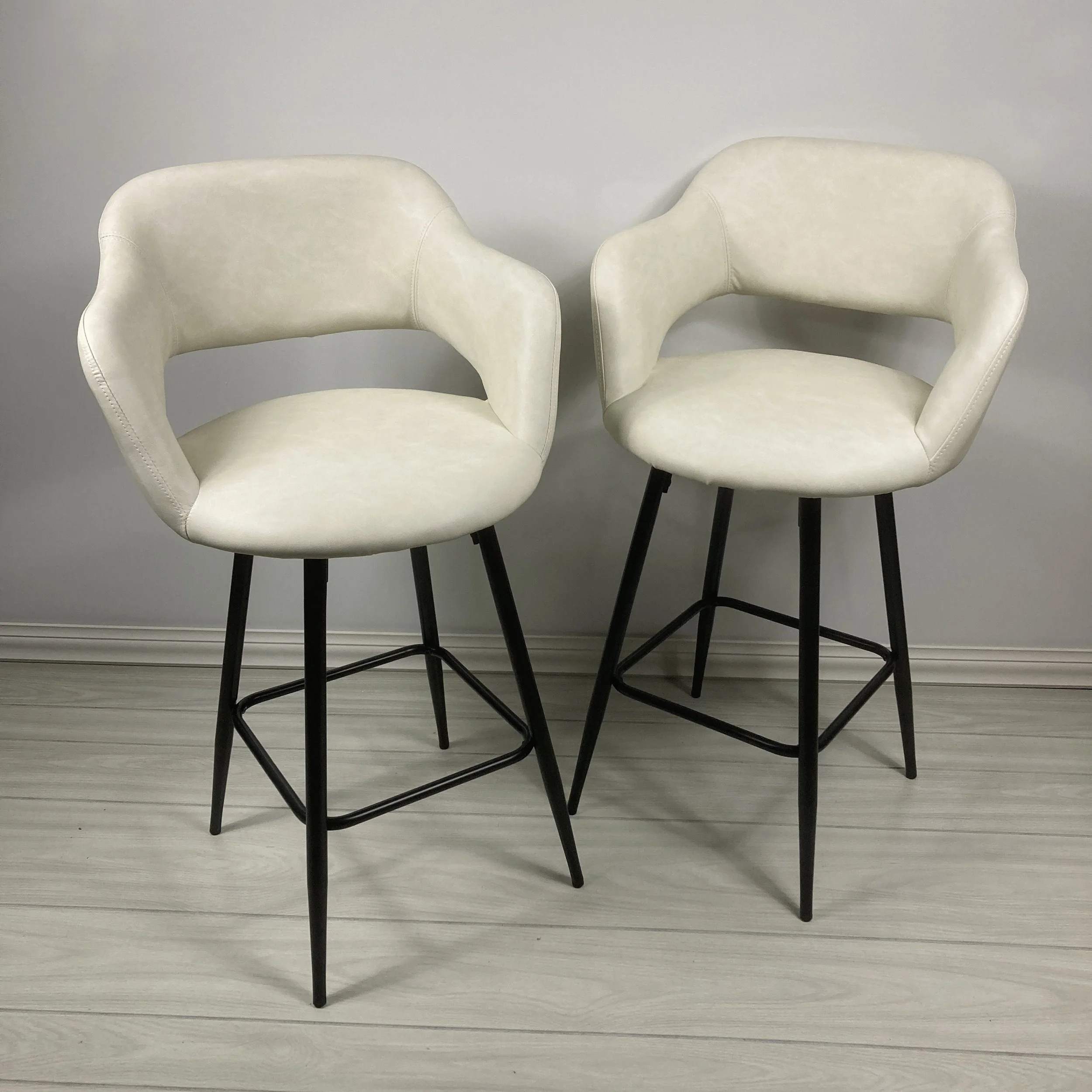 MARGARITE-25-INCH-COUNTER-STOOLS-SET-OF-2-WHITE-FAUX-LEATHER-PU-AND-BLACK-METAL-BASE-LIFESTYLE.JPG