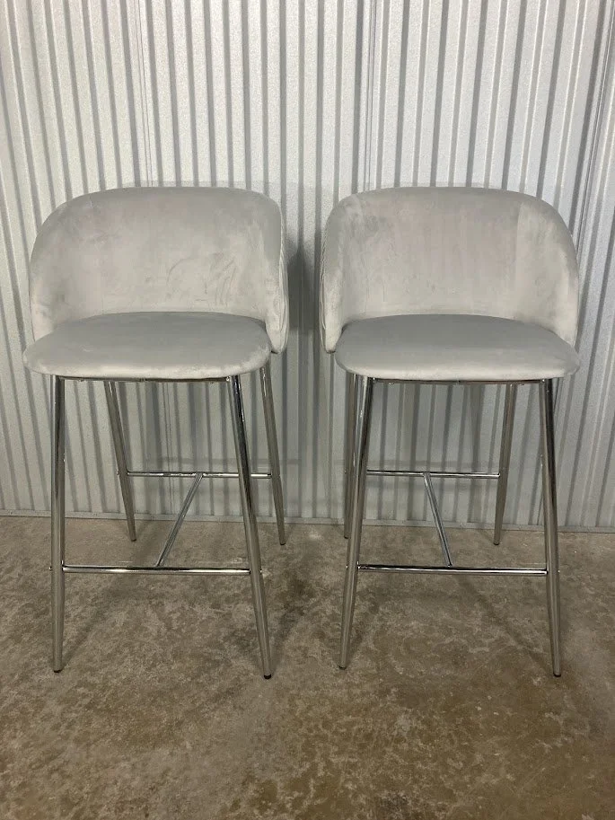 Angled view of silver velvet and chrome glam counter stools