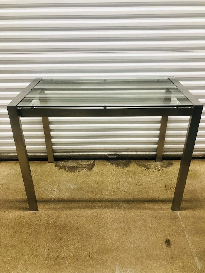 Angled view of Fuji glass counter height table with stainless steel frame