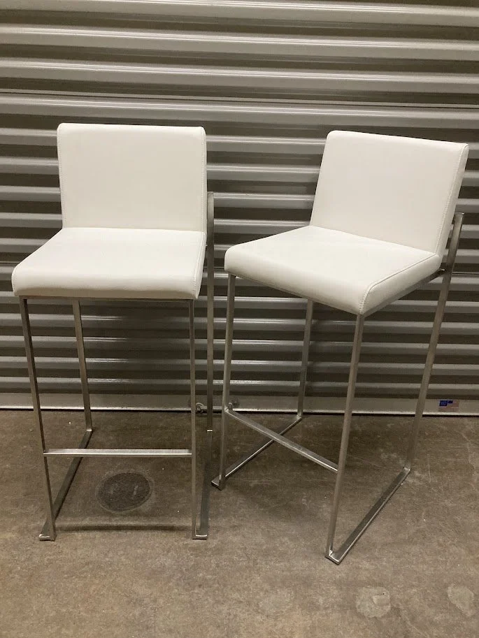 Angled view of LumiSource 30 inch white bar stool with chrome metal base