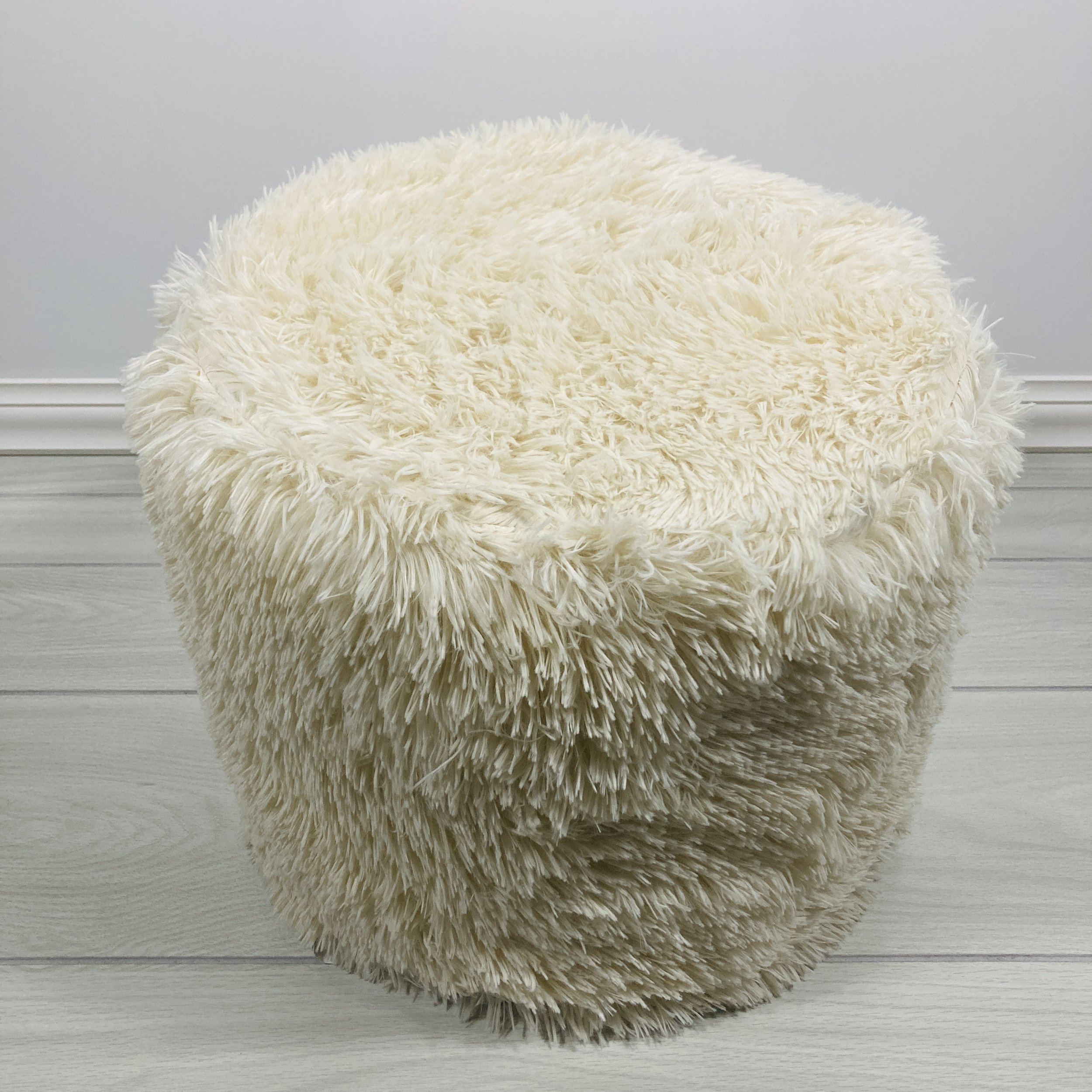 BEIGE-FAUX-FUR-UPHOLSTERED-ROUND-POUF-CLOSE.JPG