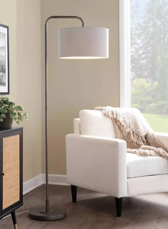 Modern oil rubbed bronze floor lamp with beige shade in living room