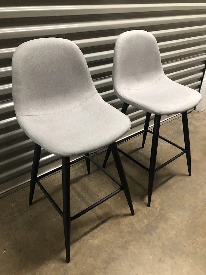 Close up of light grey fabric seat on Pebble counter stool