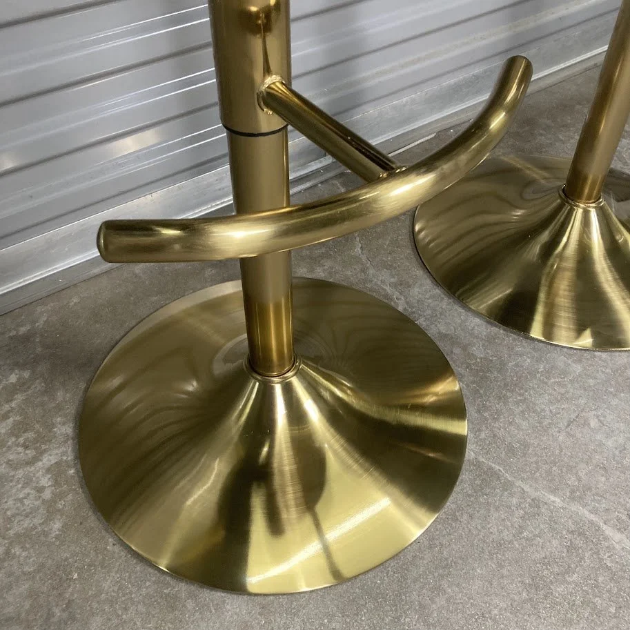 Gold metal pedestal base and footrest on LumiSource Cinch adjustable stool