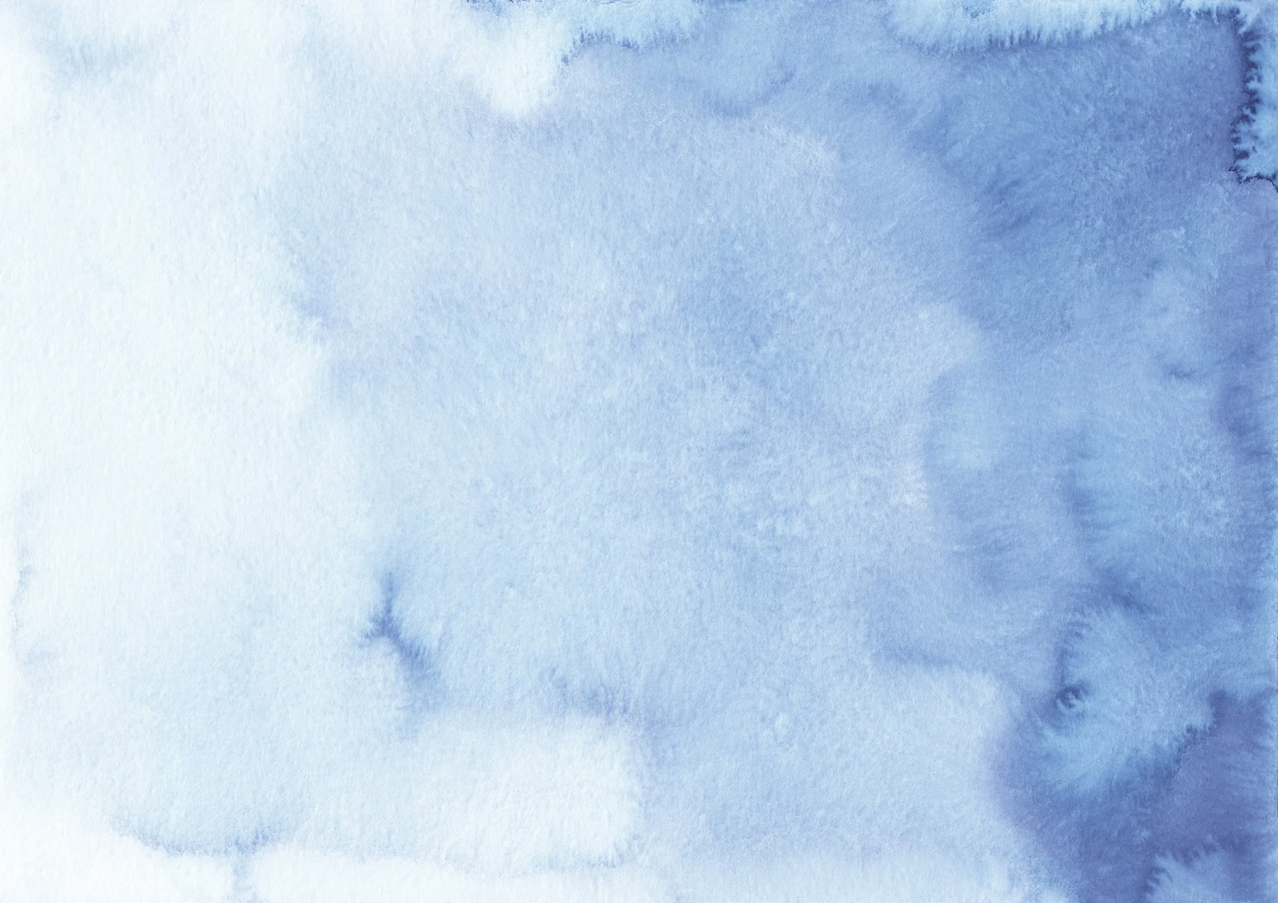 A close-up view of a blue watercolor painting or paper with varying shades of blue and soft texture.