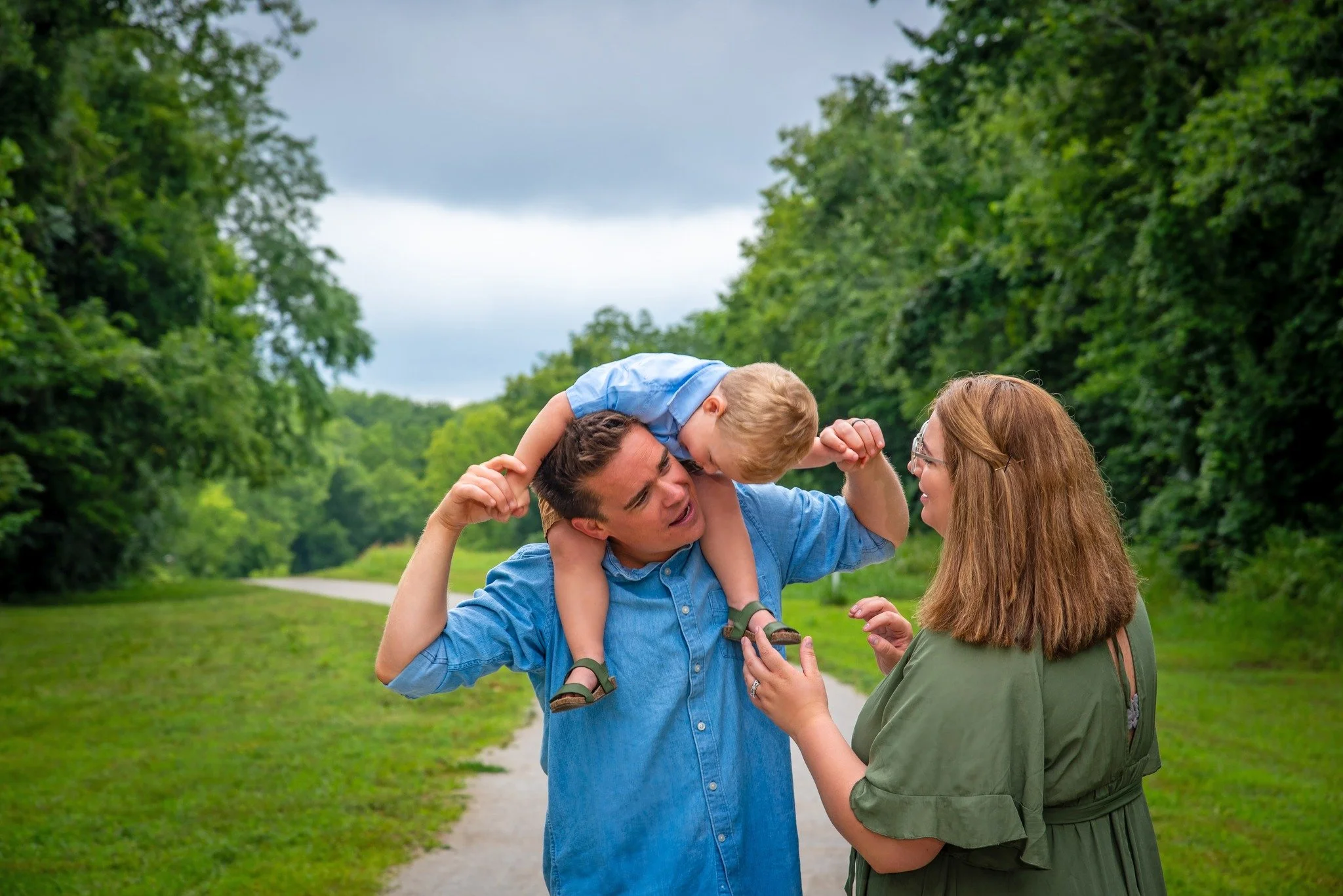 Outdoor candid family session with mom, dad and toddler son 