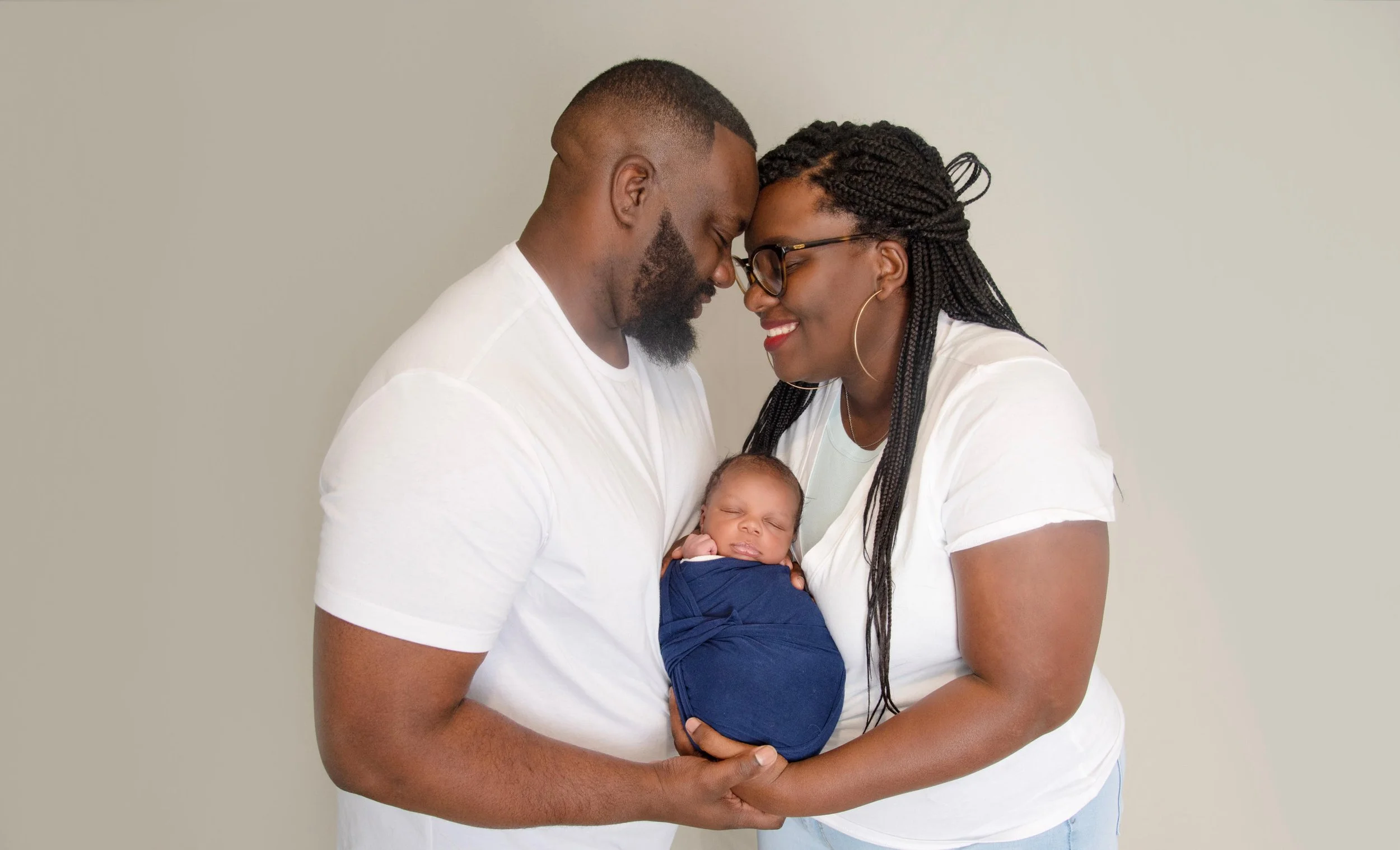 Parents holding their newborn during a Spring Texas newborn photography session