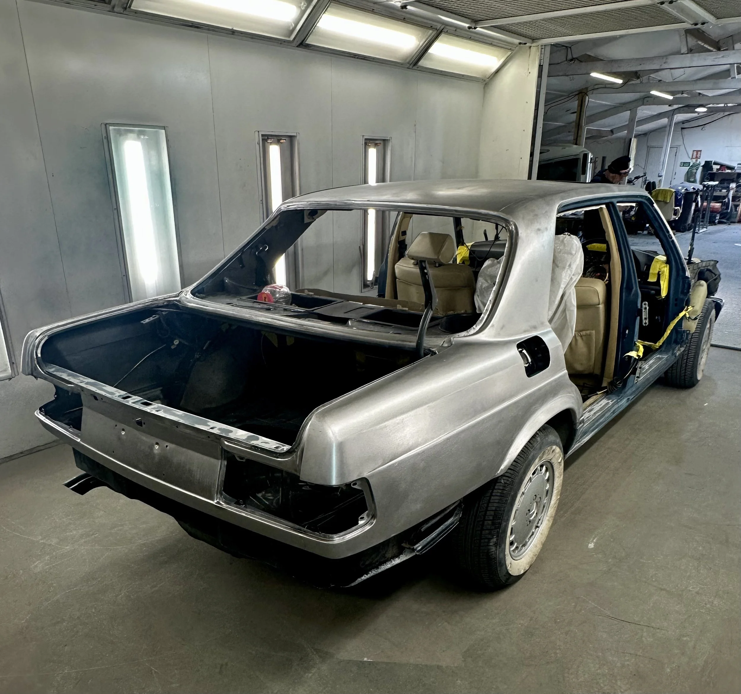 Mercedes 560SEL external bare metal repaint.