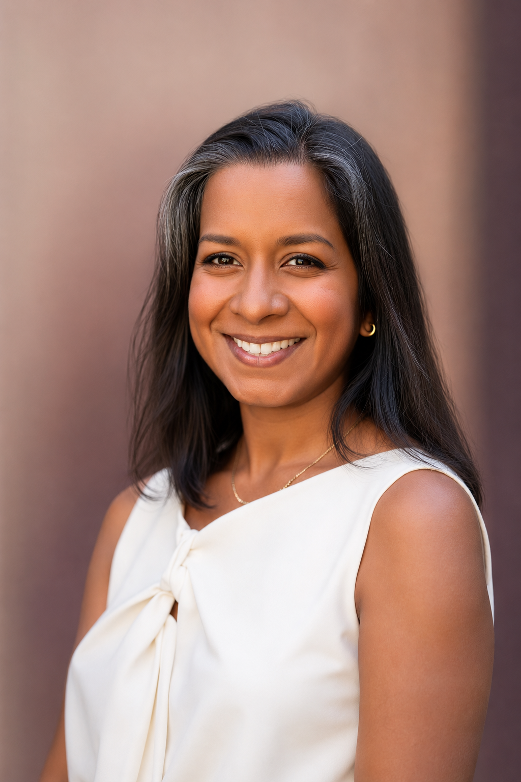 Sarah Carrigan, Founding Partner of Ember Consulting Group, smiling outdoors